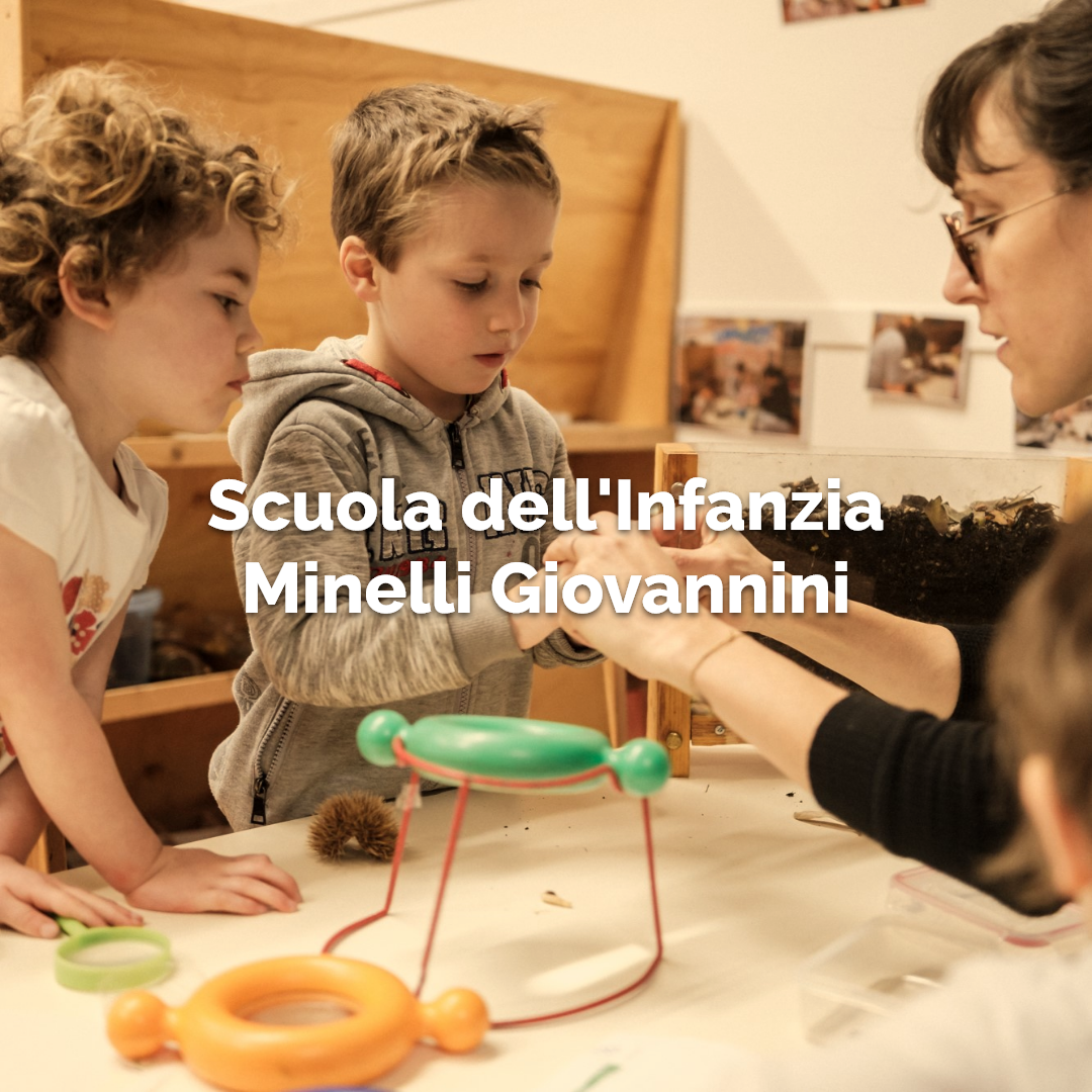 Maestra che mostra ai bambini il funzionamento di un gioco presso la scuola dell'infanzia Minelli Giovannini